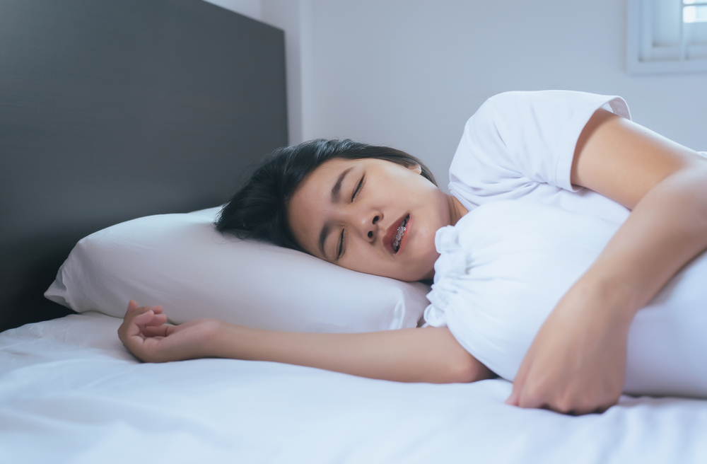 Girl grinding her teeth while sleeping Girl grinding her teeth while sleeping